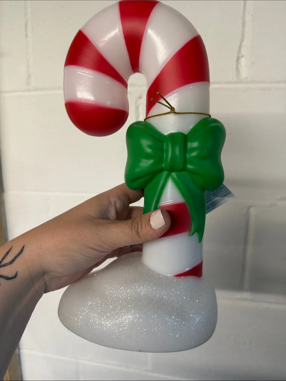 Red and White Candy Cane Ornament with Green Bow